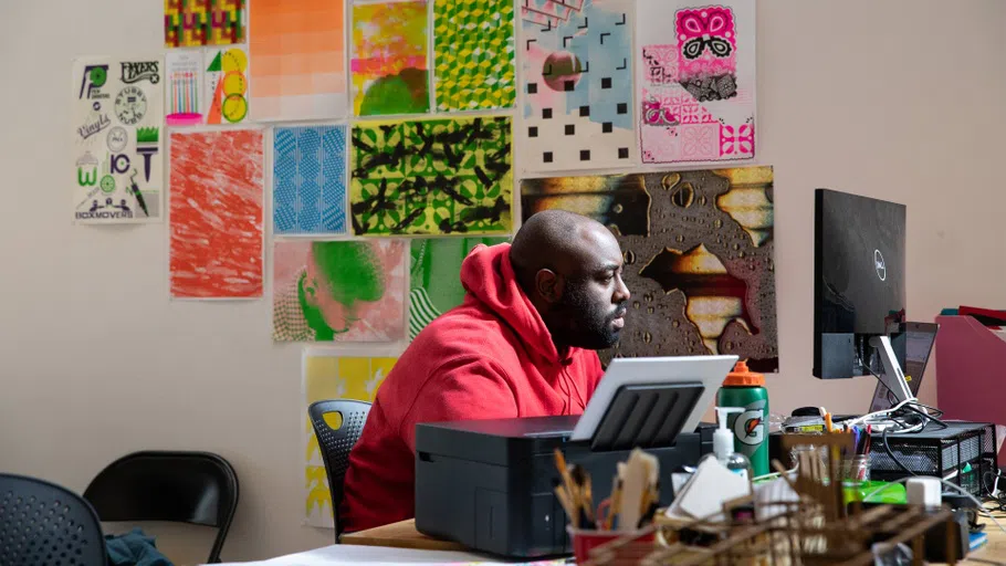 Malik Sapp sits at a computer in the MFA Design studio.