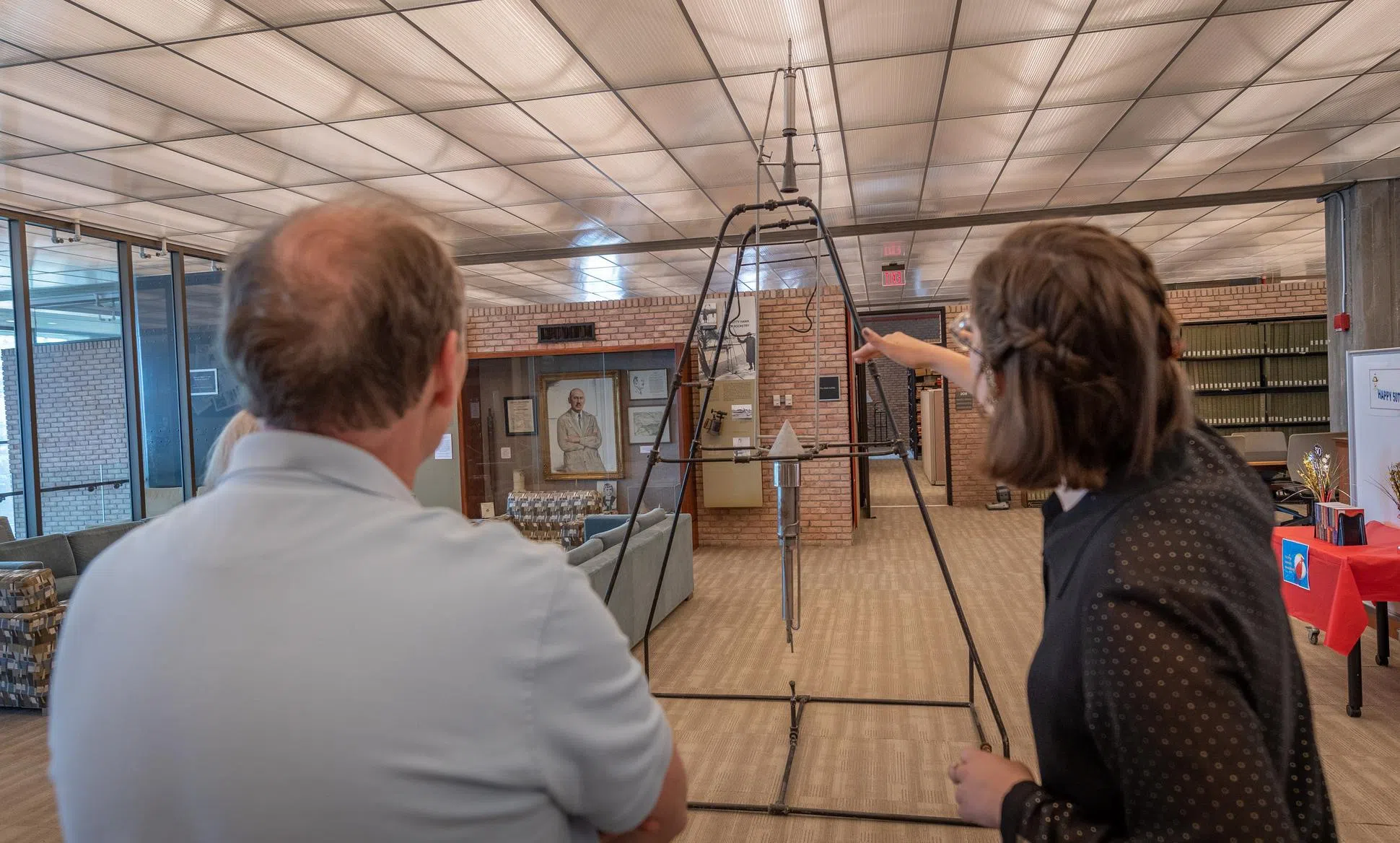 student pointing at rocket frame