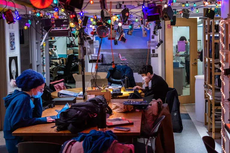 students in photo studio sitting at table