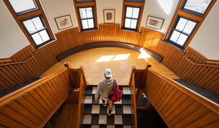 student walking up staircase