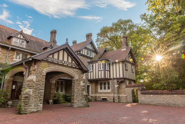 The original courtyard entrance is displayed. The original "Cabrini College" moniker still adorns the entrance.