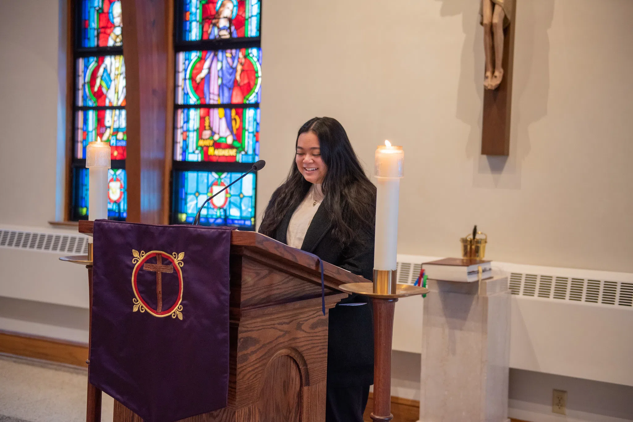 A student at a podium in the chapel