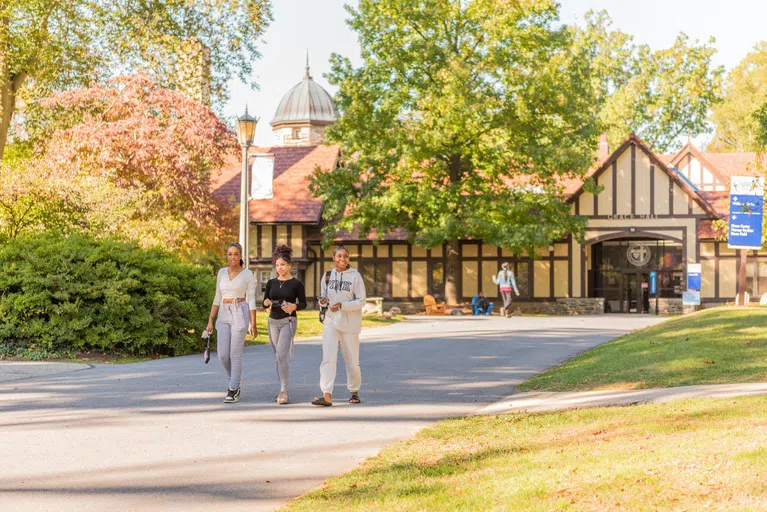 Three female students outside of Grace Hall.