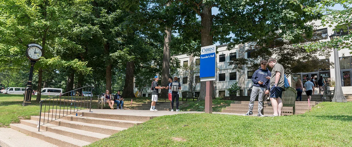 Students standing around entrance of building