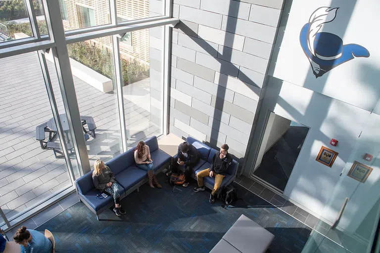 Students sitting in lobby of the Dixon Center