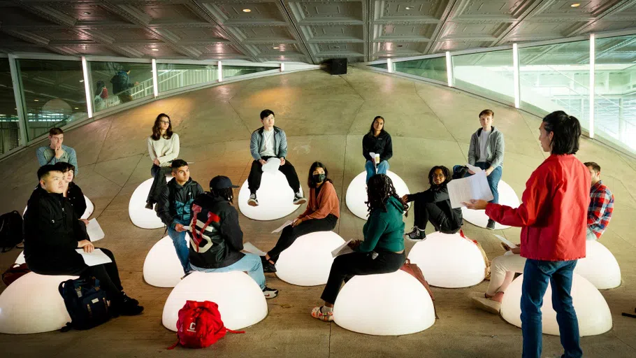 A class gathers on the unique architecture outside Milstein Hall. 