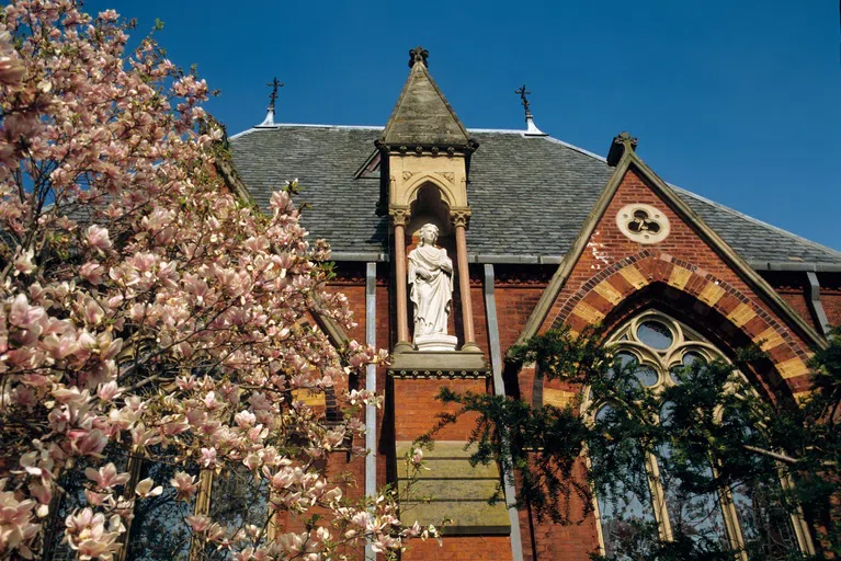 Sage Chapel seen during springtime, with flowering trees in the foreground.