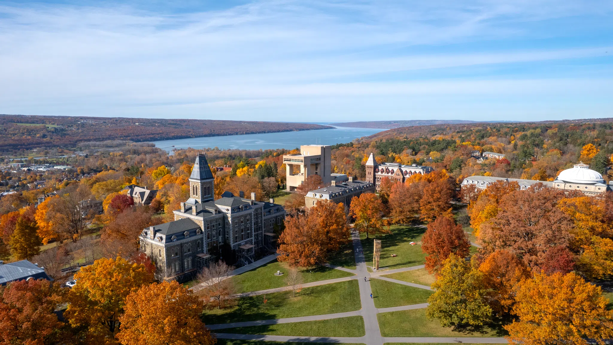 Aerial view of the Arts Quad with fall foliage and Cayuga Lake in background.