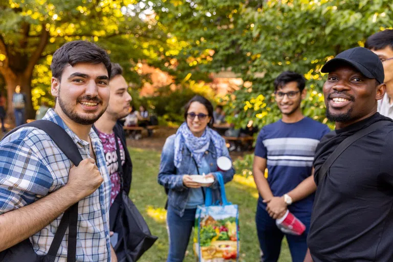 A group of graduate students enjoy an outdoor picnic.