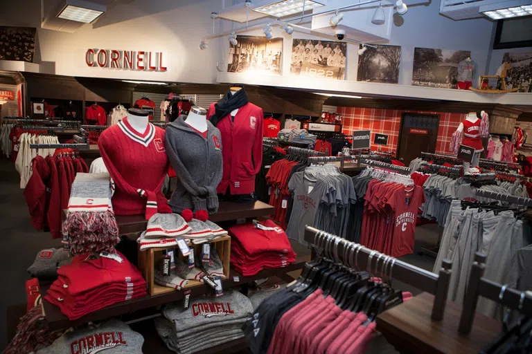 Shelves, racks and display full of dozens of Cornell-brand clothing and merchandise.