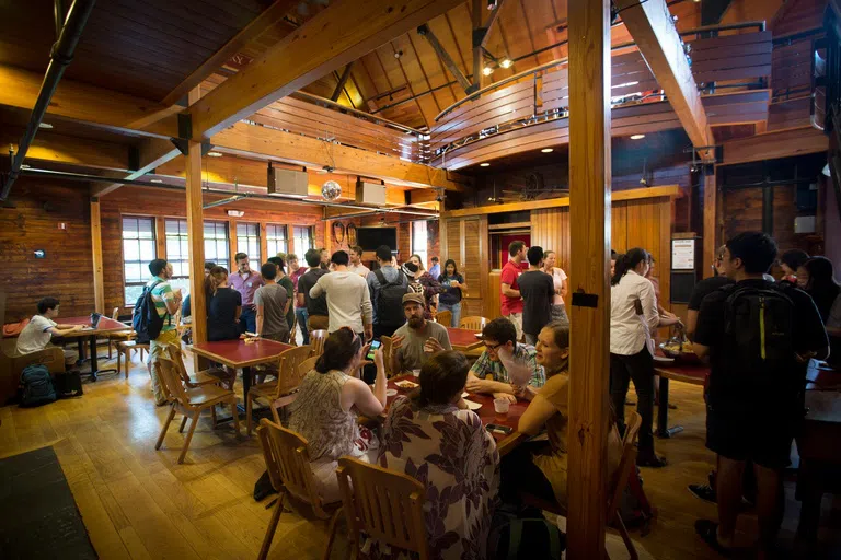 Grad students enjoy an informal social at the Big Red Barn's indoor cafe.