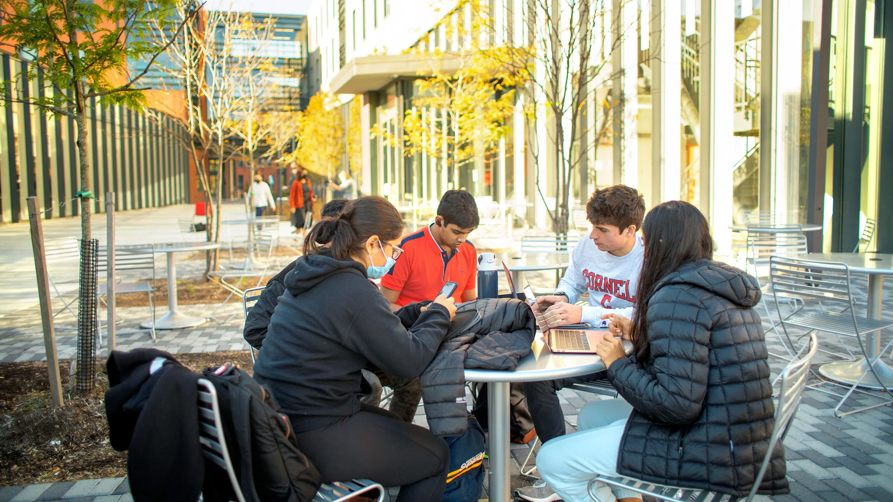 Students hang out in a courtyard adjacent to Toni Morrison Hall.