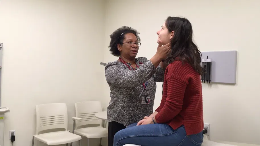 A medical provider at Cornell Health evaluates a patient.