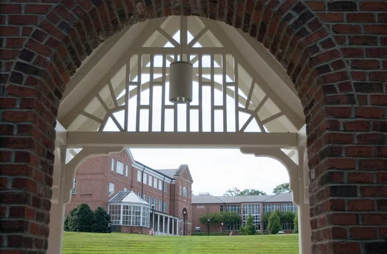 View of Rainey Amphitheatre through the arched, wooden facade of the stage structure.