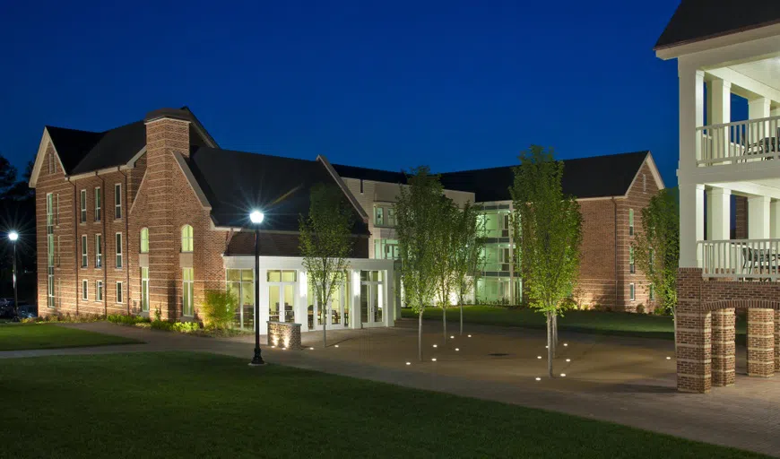 Landscape view of residence hall building at night.