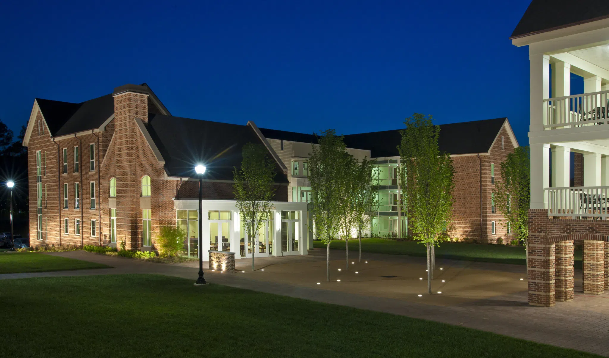 Landscape view of residence hall building at night.