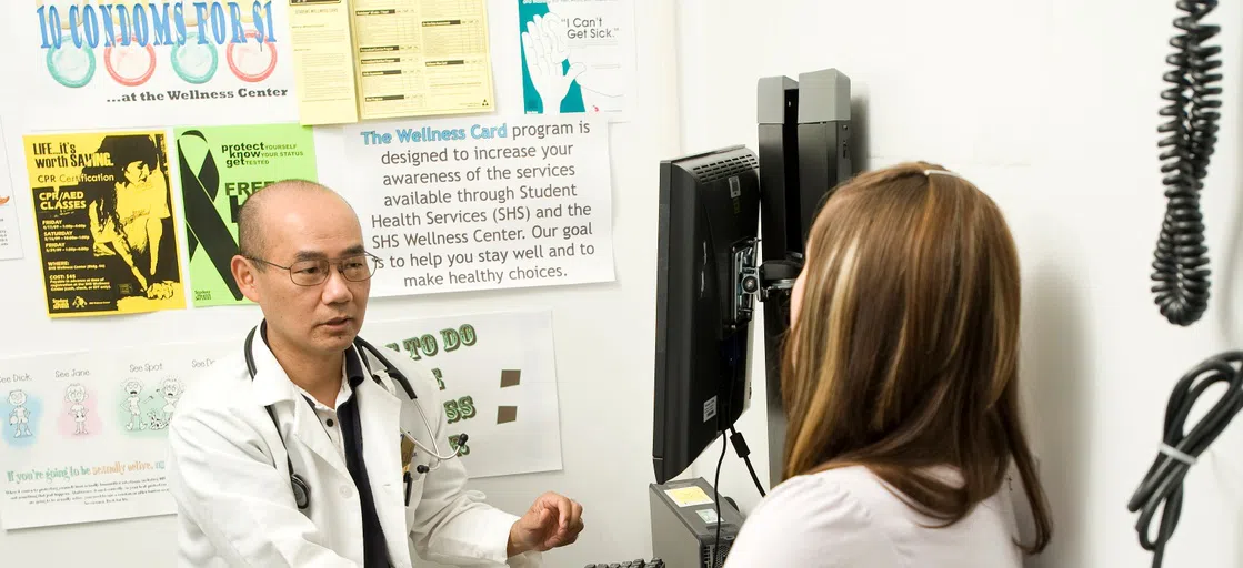 Doctor sits with patient