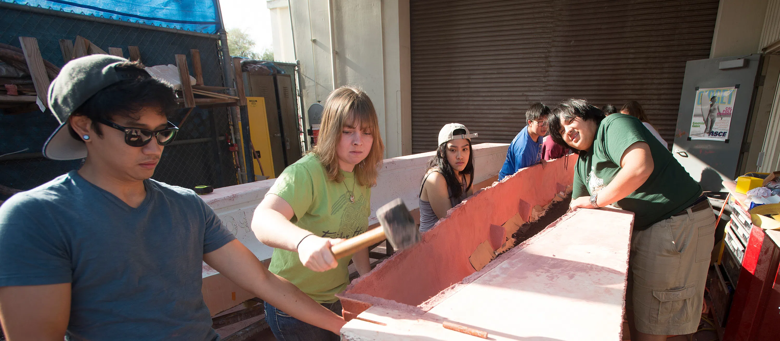 students working on concrete canoe