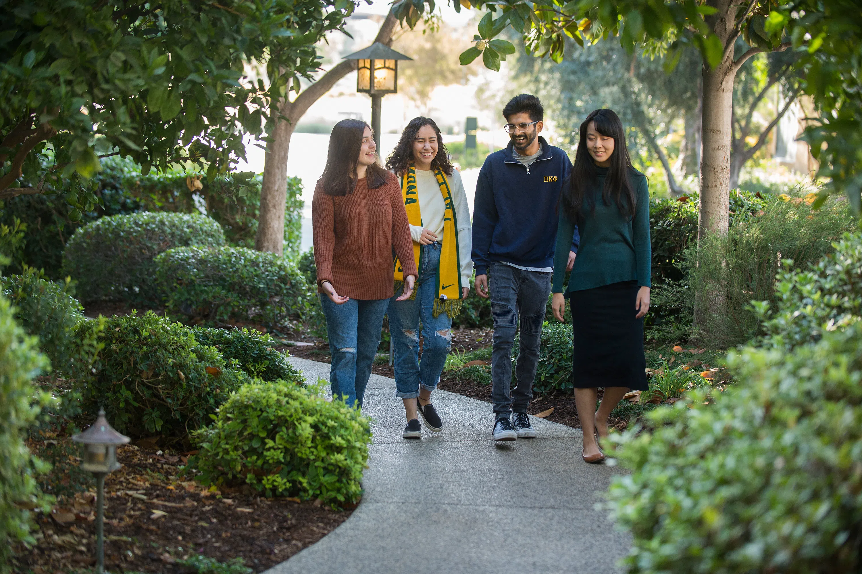 four students walking in a Japanese garden