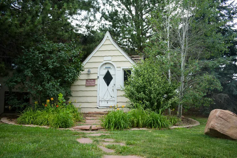 Small yellow chapel with a curved door and window to the right