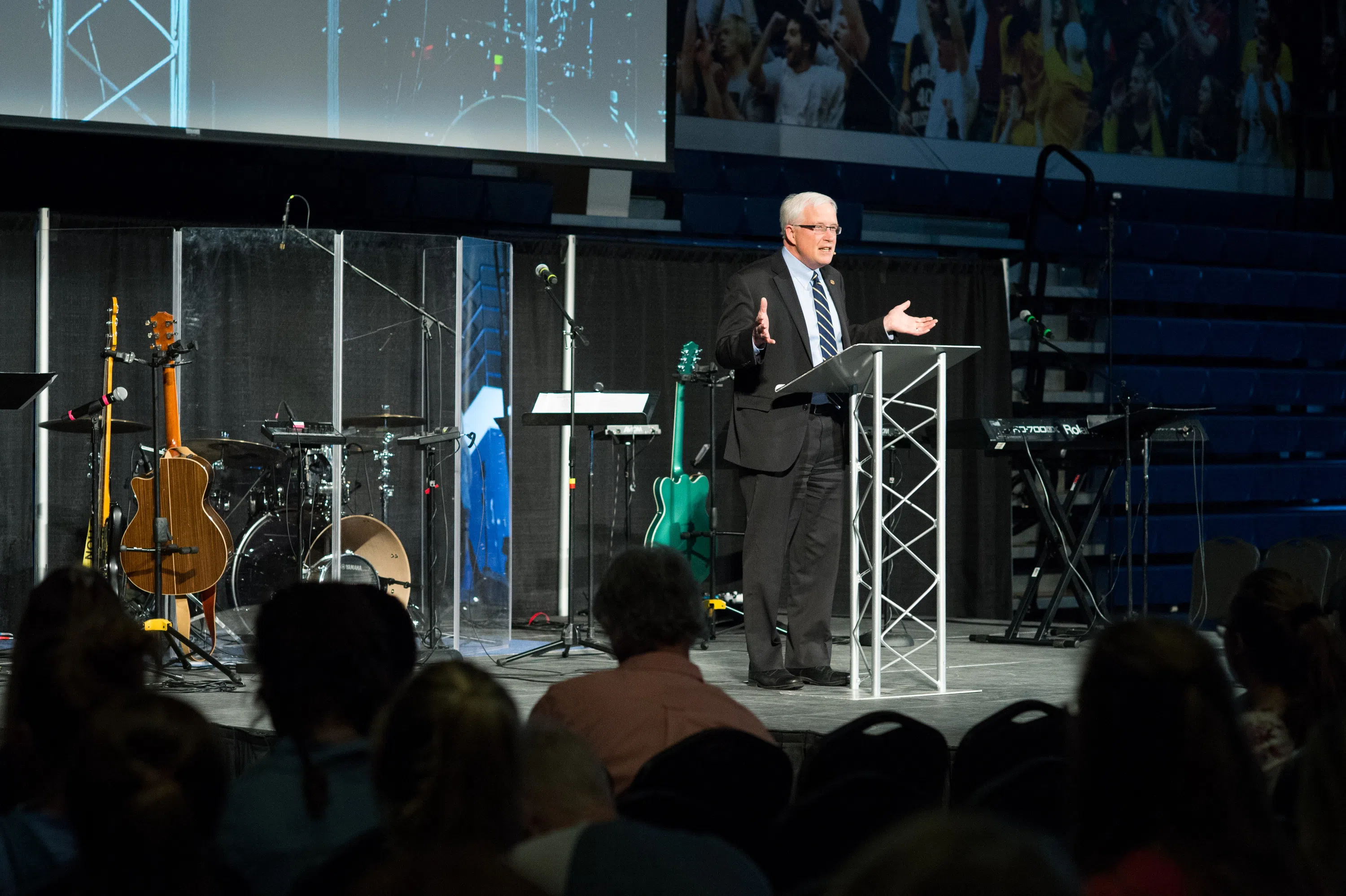 President Don Sweeting talking on stage at chapel