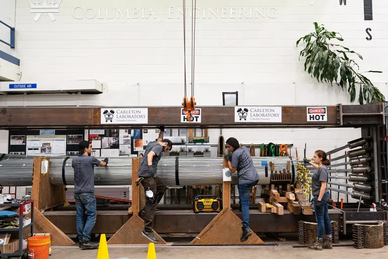 Four students are working in a construction lab.