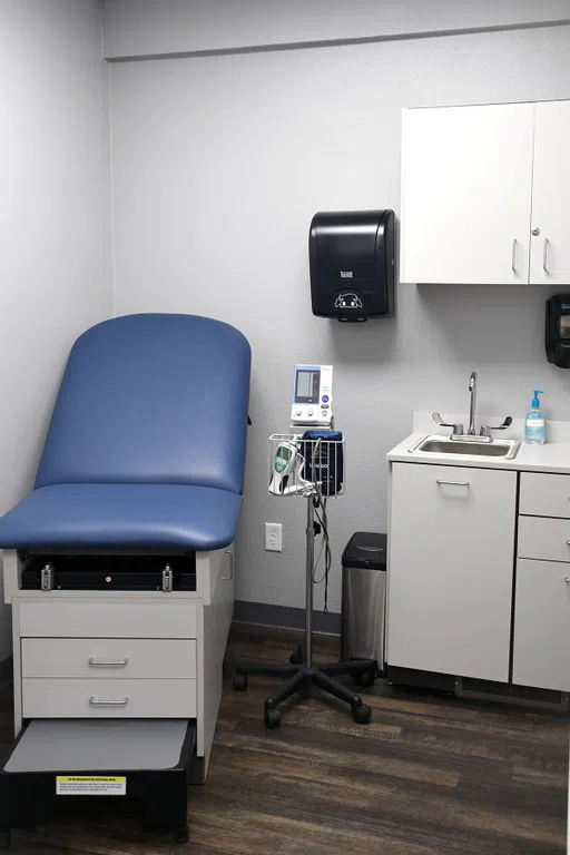 A medical office with professional examination tables and equipment for monitoring students' health