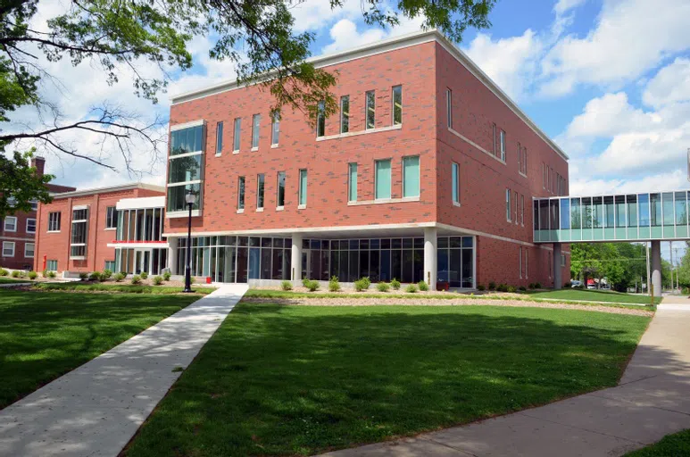 Fine Arts Building-Exterior, a large brick building with cube-like dimensions, lots of window, and a glass walkway connecting the second story to Main Hall