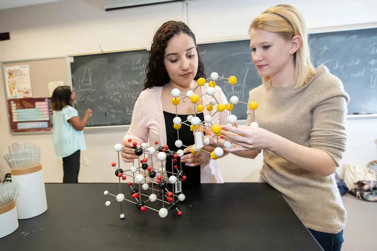 Students manipulating a model of a molecule