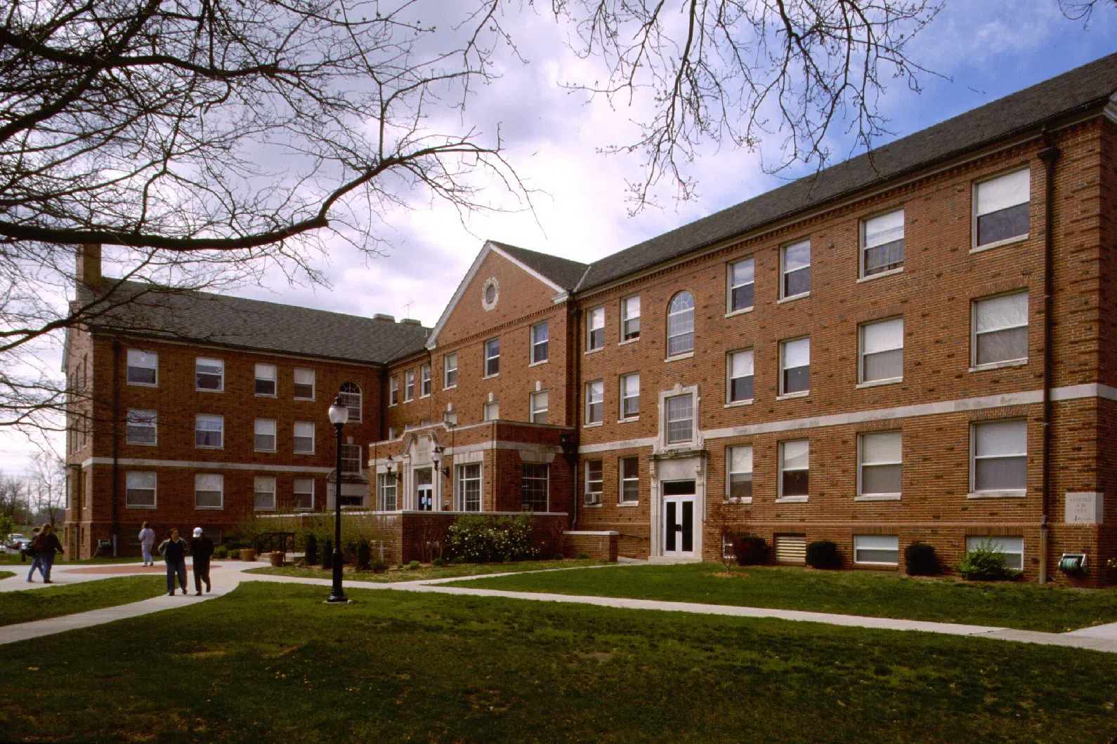 A large building with many windows, indicating the many dorm rooms inside