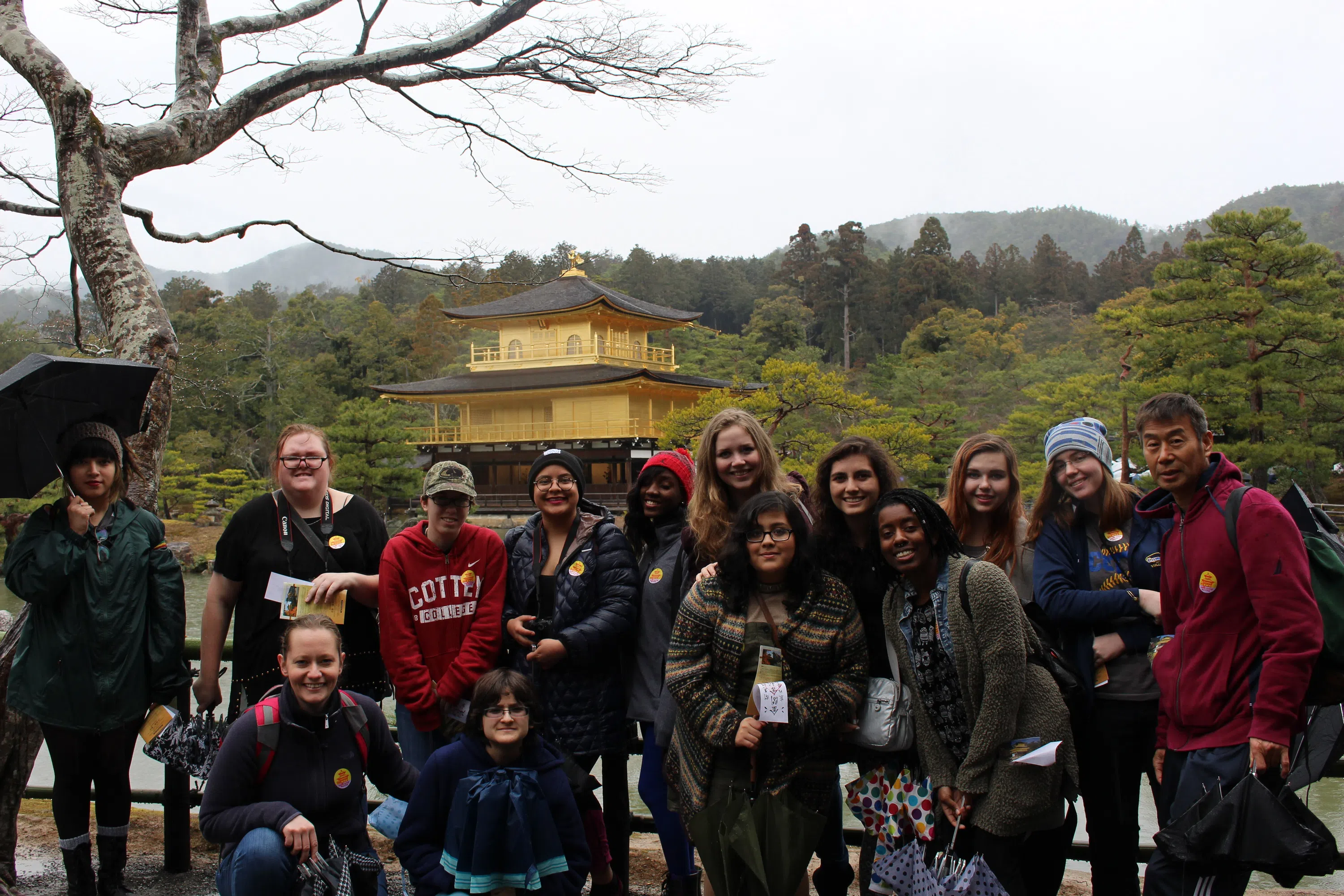 Students in front of a beautiful Japanese building surrounded by vegetation