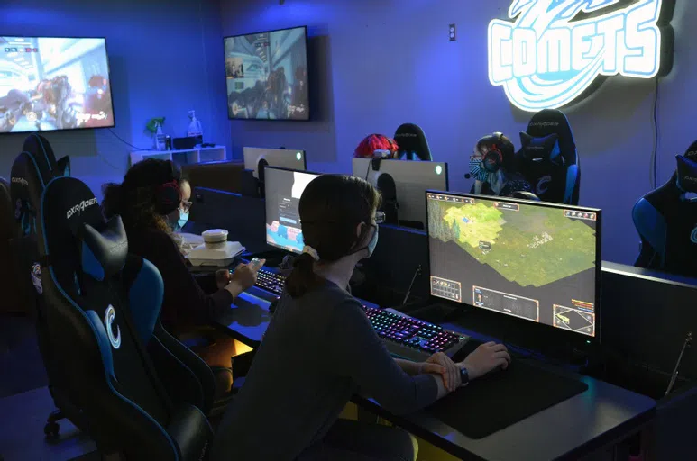 Blue light sets the mood in this technological wonderland. Rows of tables with state-of-the art computers, gaming chairs, and large televisions bolted to the wall make this the perfect space for practicing esports