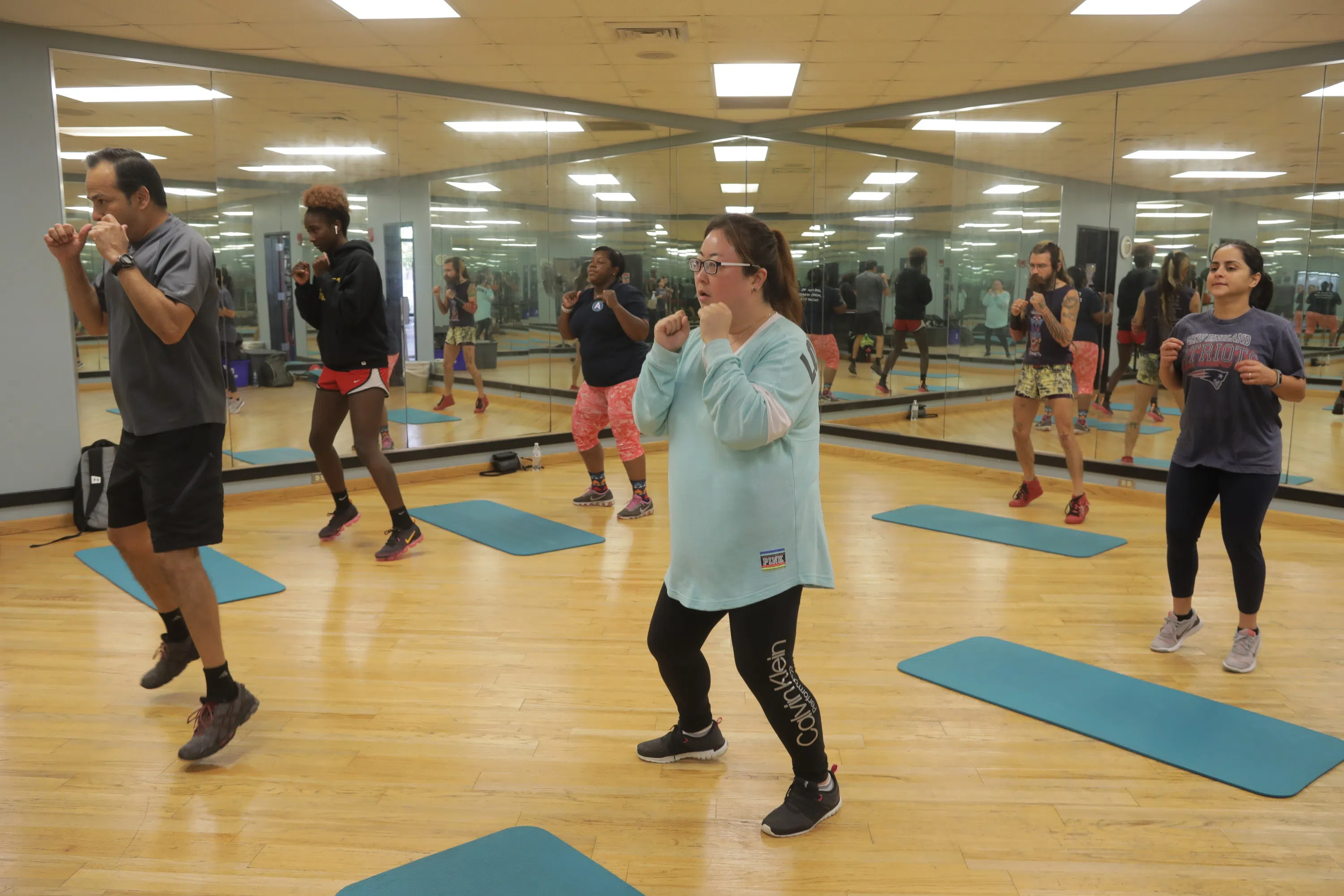 people in work out room in fitness class