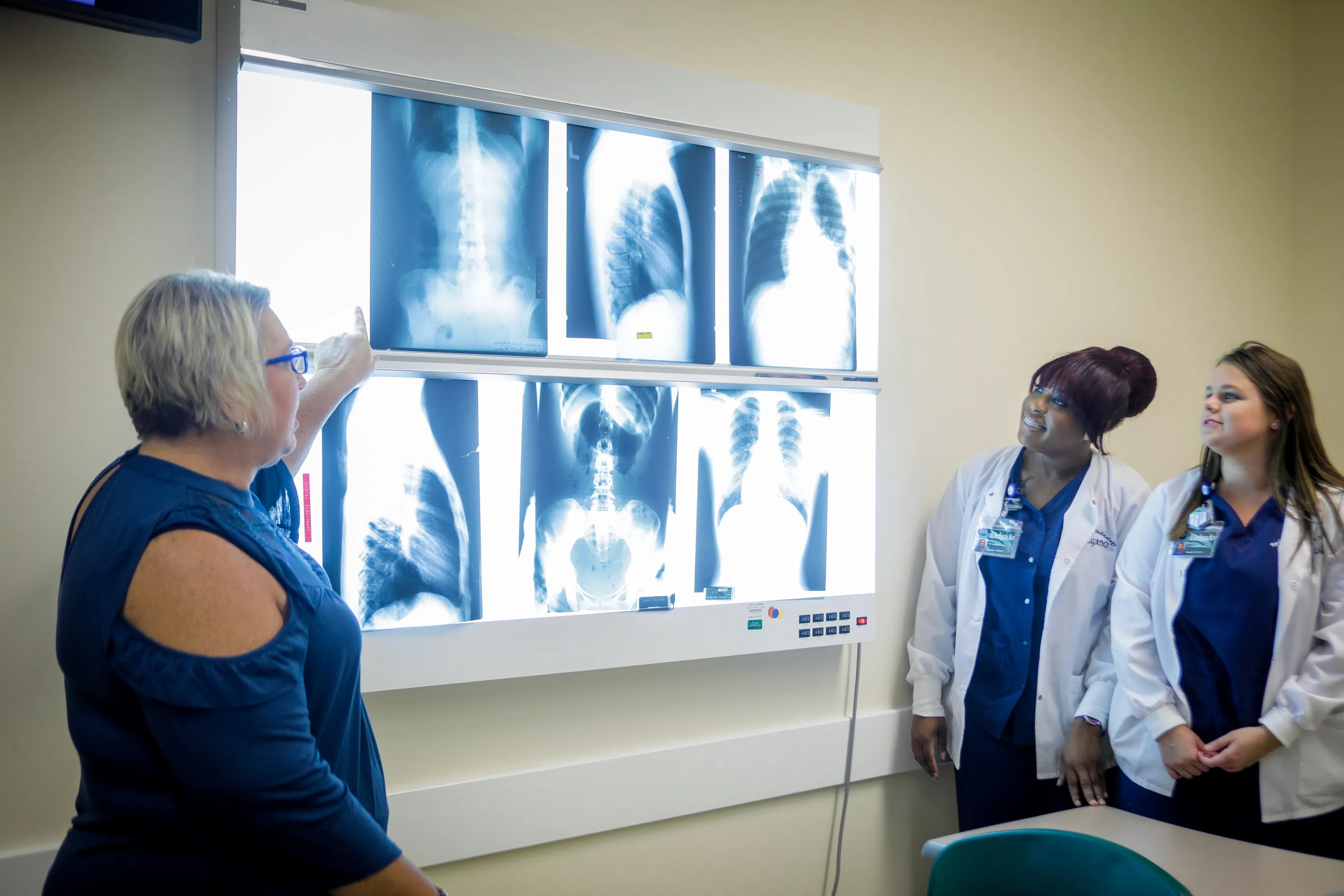 healthcare students and instructor look at x-ray film