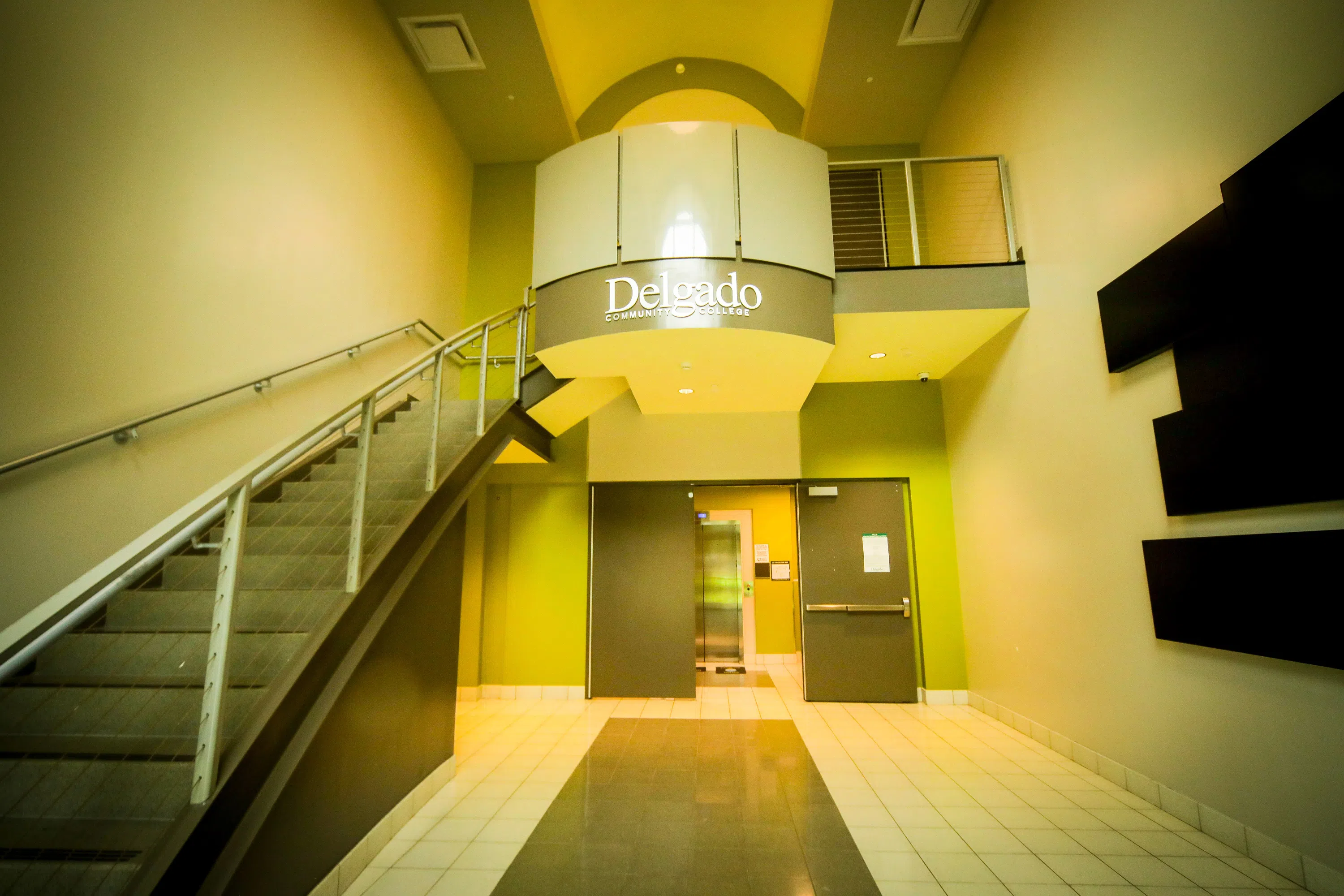 inside of a building, stairway on left, balcony at front