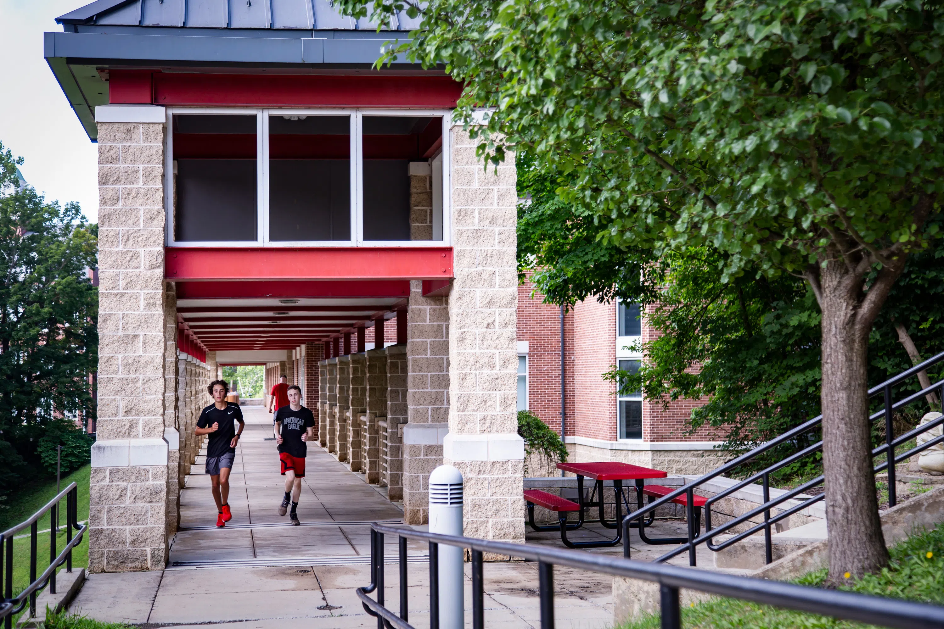 Students walking on Booth Library bridge. 