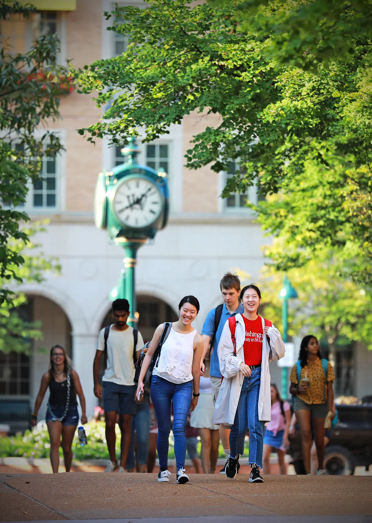 Students walk across the South 40 in front of the Clock Tower