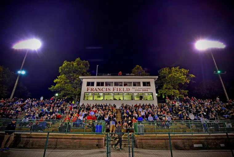 Fans in the stands at Francis Field during a night time game