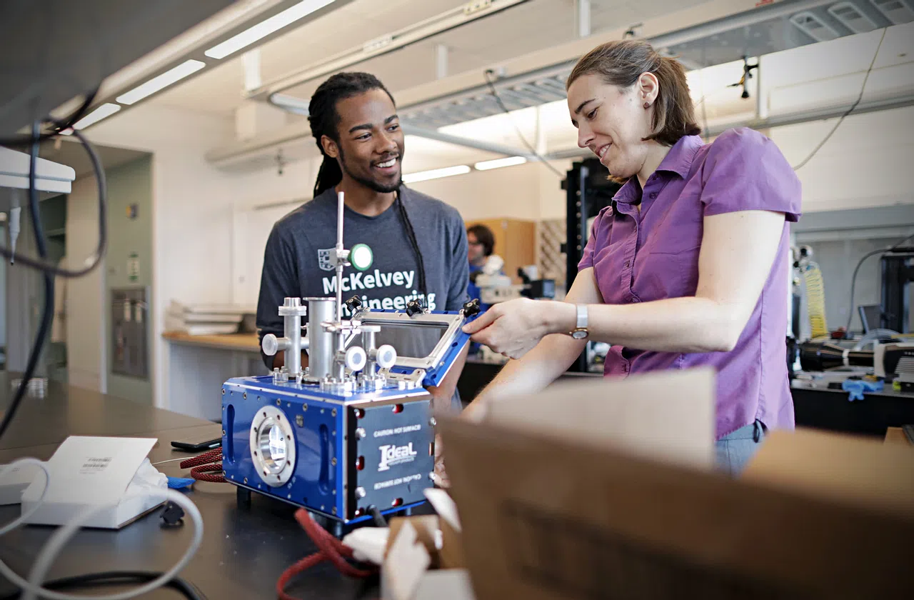 Two people engaged in conversation over research.