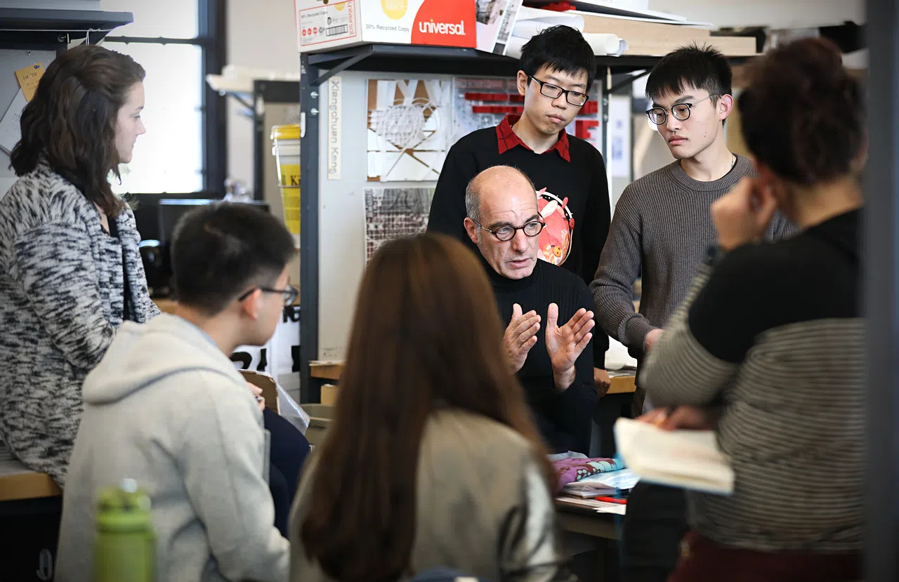 Students gathered around a faculty member in Weil