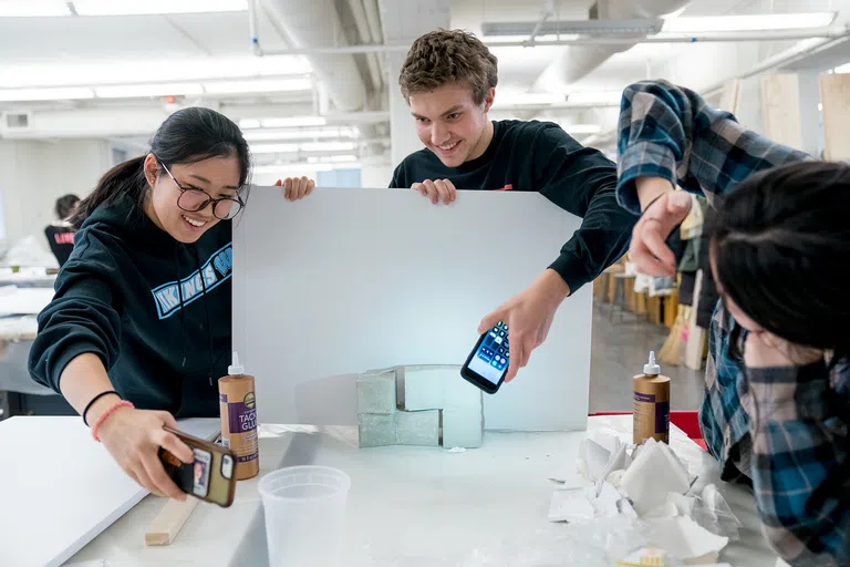 Students working to photograph an architectural model