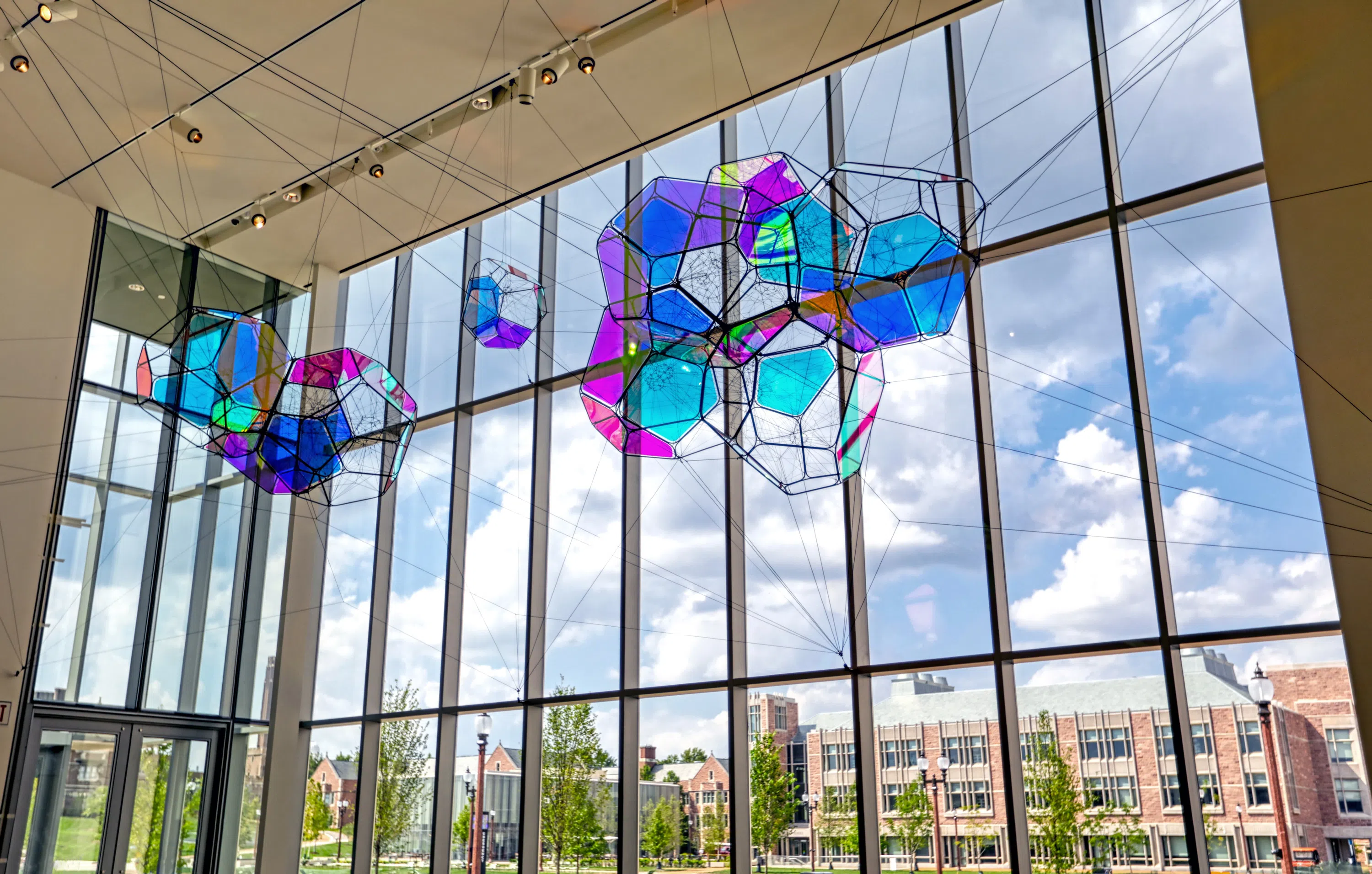 Interior shot showing the art hanging from the ceiling in the museum lobby