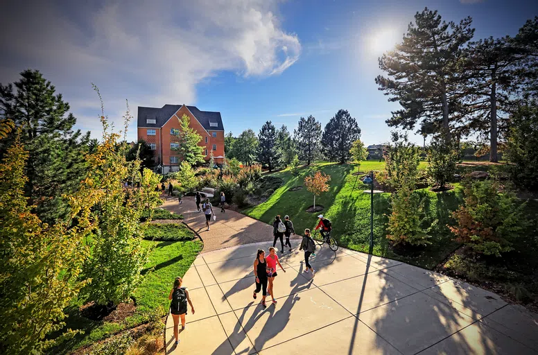 Students walk in to the South 40 from the Underpass