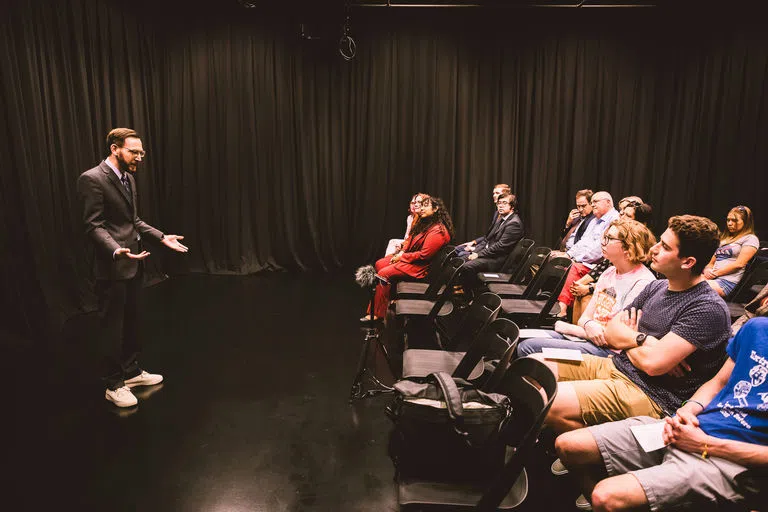 Male presenting in front of crowd