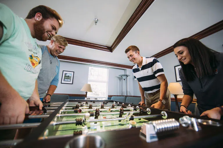 Students playing foosball in Hansen Hall