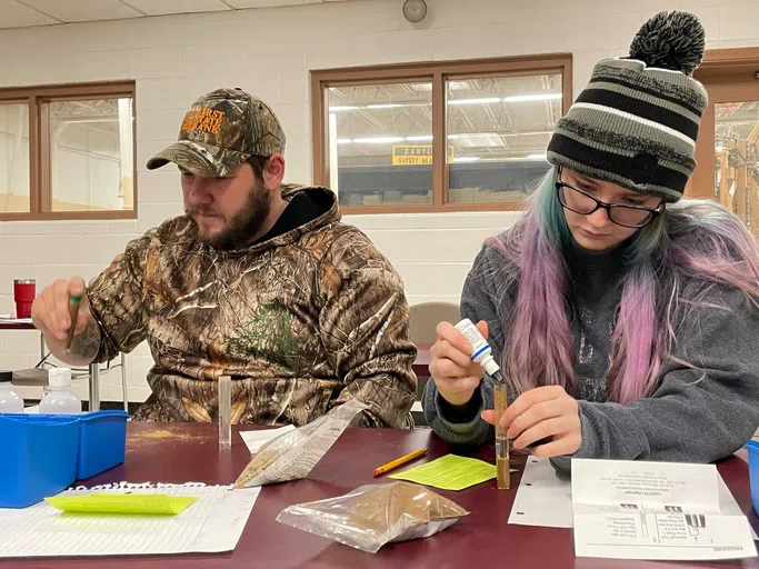 Agriculture students test soil samples.