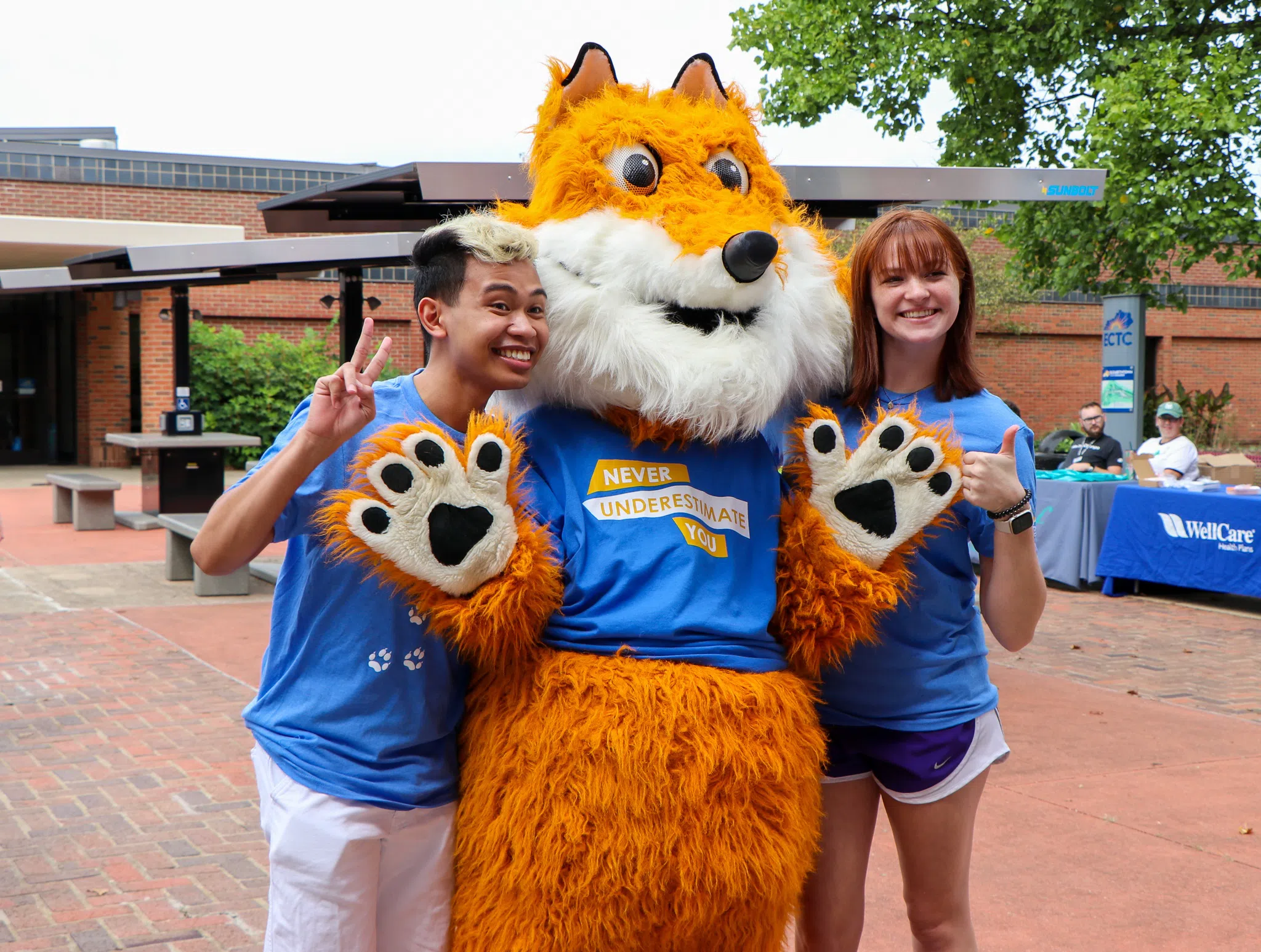 ECTC's mascot Pathfinder gives a thumbs up with his friends.