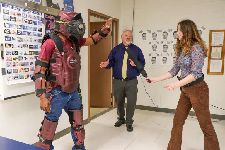 Criminal Justice student learns safety techniques with combat suit.