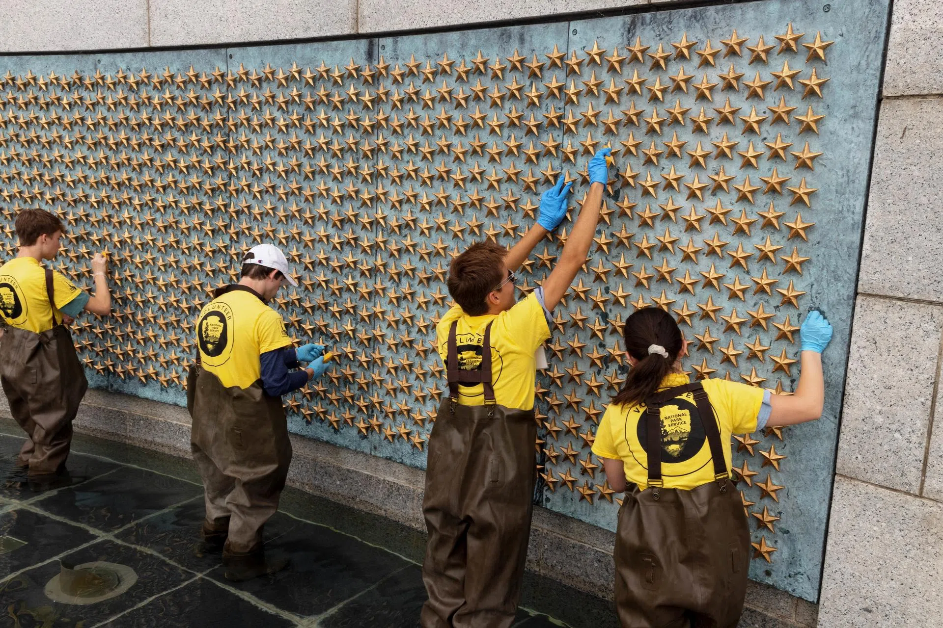 Students cleaning the World War II Memorial