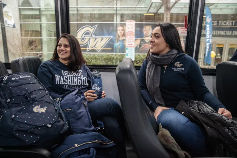 Students riding the bus wearing GW apparel